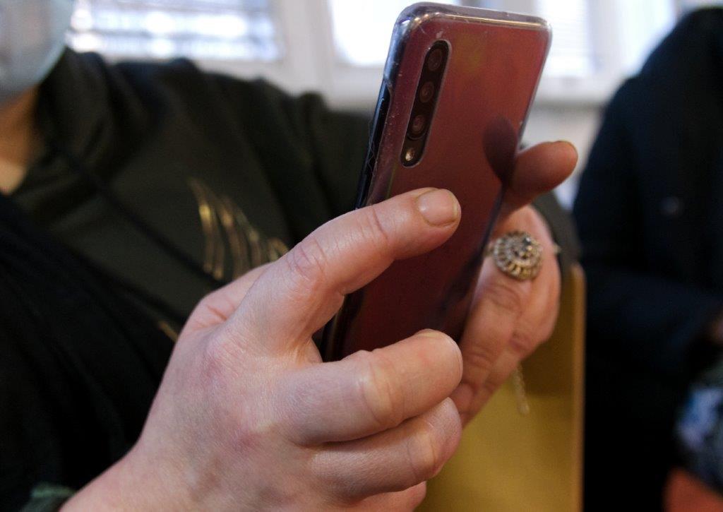 Un téléphone portable dans les mains d'une dame à la bibliothèque