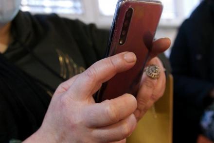 Un téléphone portable dans les mains d'une dame à la bibliothèque